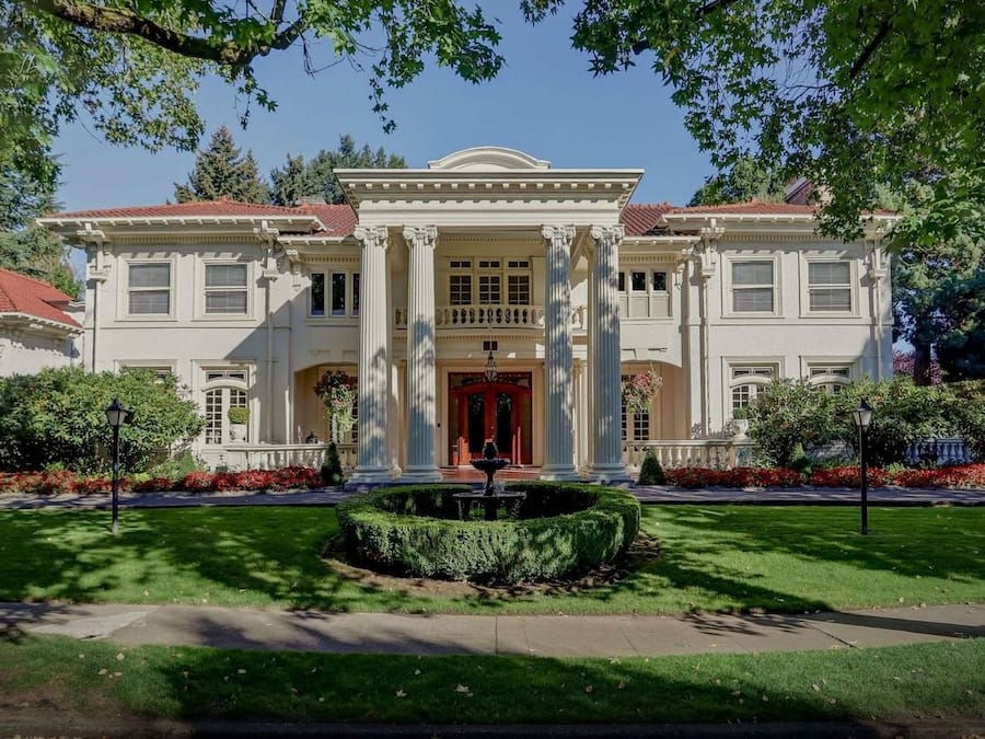 A stately building with a symmetrical facade, large windows, and a central entrance.
