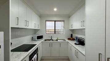 Coffee/tea maker, fridge, microwave, oven