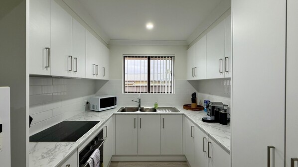 Coffee/tea maker, fridge, microwave, oven
