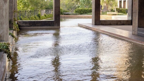 A spacious indoor pool with a view of greenery and buildings. - Mr. W | Modern 2 bedroom apartment in Providencia (Zapopan)