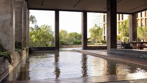 An indoor swimming pool with a view of buildings and greenery outside. - Mr. W | Modern 2 bedroom apartment in Providencia (Zapopan)