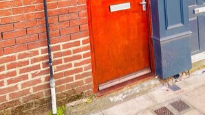 A red door with the number 58, a black pipe, and a blue gate. - Kensington Studio, 2nd-Floor City Base (Kensington)