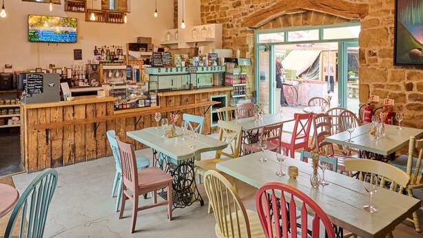 A rustic interior with wooden furniture, a bar area, and a stone wall. - The Loft On The Yorkshire Dales (Ripon)