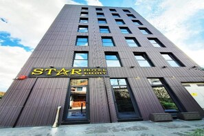 A tall hotel building with a modern facade, large windows, and a prominent 'STAR HOTEL LIGHT' sign. - Hotel Star Light Tirane (Tirana)