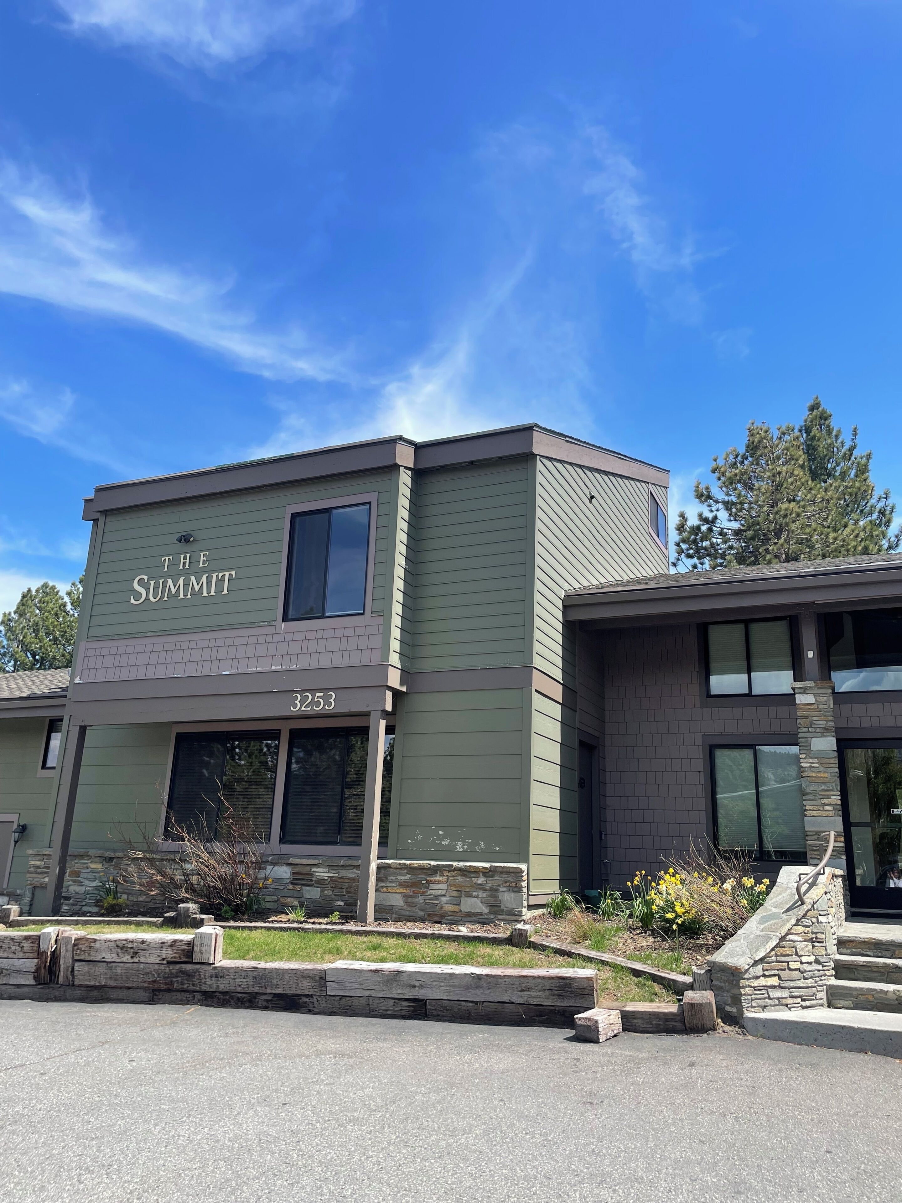 A two-story building with the sign 'THE SUMMIT' and the number '3253' on the front.