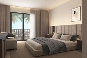 Un dormitorio moderno con una cama grande, un escritorio y vistas a palmeras a través de la puerta de cristal.
