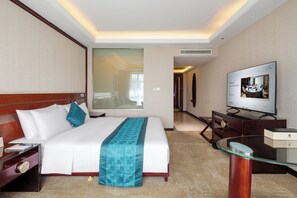 A hotel room with a bed, a TV, a desk, and a mirror. - shanxidasha (Beijing)