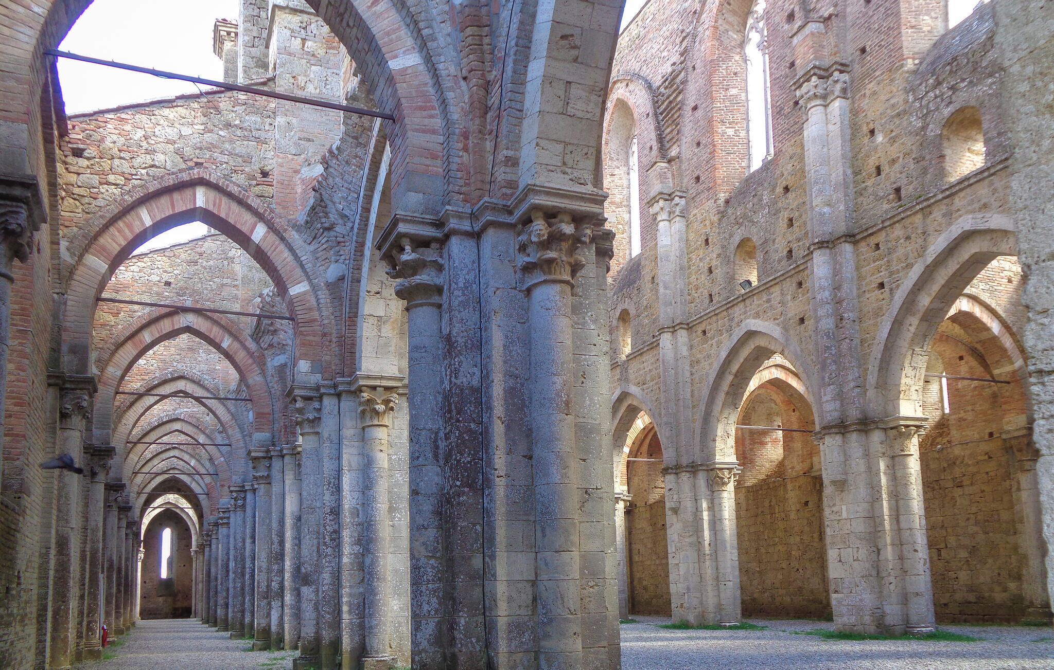 A historical building with a series of arches and columns, likely a cathedral or abbey.