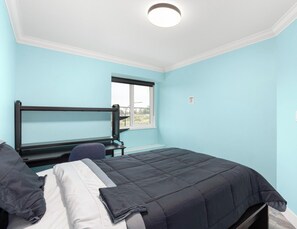 A bedroom with a single bed, a window, and a door. - Modern 5BR Home Near Lions Gate Glass Deck BBQ (West Vancouver)