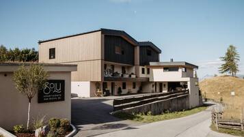 A modern building with a sign for 'Solu Apartments AM Bichl 36'.