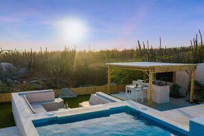 A pool with a pergola and seating area, surrounded by a natural landscape. - LUX 4BR Modern Villa • Pool Oasis • Villa Graziano (Noord)