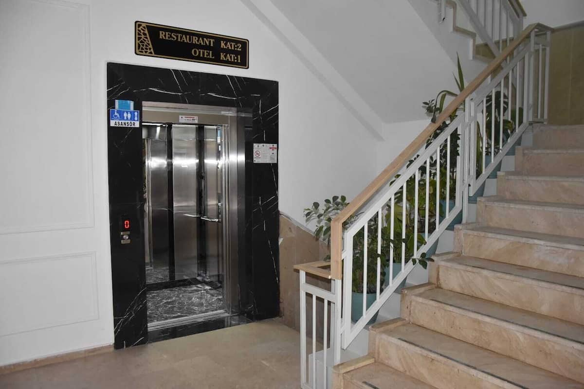 An elevator with a sign indicating 'Restaurant Kat:2' and 'Hotel Kat:1' above it.