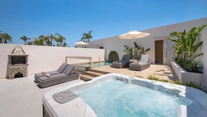 A rooftop pool area with a hot tub, lounge chairs, and a stone fireplace. - Two Bedroom Villa with Private Pool (Rhodes)