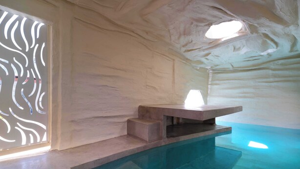 An interior with a stone bench, a small pool, and a frosted wall. - Two Bedroom Villa with Private Pool (Rhodes)