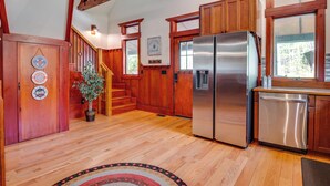 A kitchen with wooden cabinets, a stainless steel refrigerator, and a dishwasher. - Hot Tub, Game Room! Stunning Home By Short Sands (York)