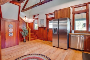 A kitchen with wooden cabinets, a stainless steel refrigerator, and a dishwasher. - Hot Tub, Game Room! Stunning Home By Short Sands (York)