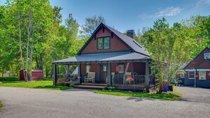 A two-story house with a porch, a chimney, and a garage. - Hot Tub, Game Room! Stunning Home By Short Sands (York)
