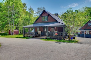 A two-story house with a porch, a chimney, and a garage. - Hot Tub, Game Room! Stunning Home By Short Sands (York)