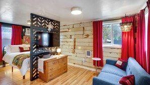A room with a bed, a sofa, a TV, a dresser, and a window with curtains. - Units 1 & 2: Two Suites, Sleeps 4, 3 Mi to Dtwn (Spokane)