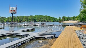 A marina with docked boats, a wooden walkway, and a sign for BSR Line. - Amazing Views! Family-Friendly Badin Lake House! (New London)