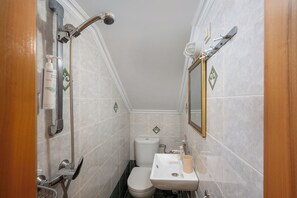 A small bathroom with a shower, toilet, sink, and mirror. - Pinotsi Room 5 -2 single (Simi)