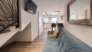 A modern interior with a staircase, a sofa, a dining area, and a kitchen. - 2 bedroom awesome home in Jadranovo (Jadranovo)