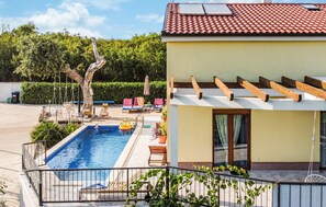 A swimming pool with a pergola, lounge chairs, and a garden area. - Awesome home in Dobrinj (Dobrinj)