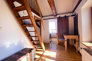 A wooden staircase leading to a loft bedroom with a view of the outside. - Holiday home in Bugewitz with swimming pool (Bugewitz)