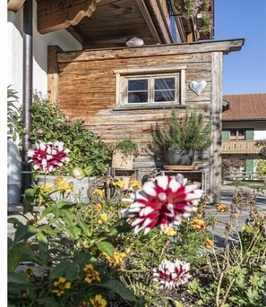 Ein Holzhaus mit Fenster und herzförmiger Dekoration an der Wand.