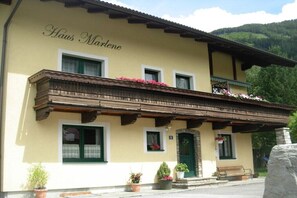 A building with a sign reading 'Haus Marlene,' featuring a balcony with wooden railings and flower boxes. - Holiday apartment with 2 bedrooms (Rauris)