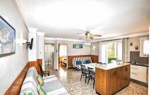 A compact living space with a kitchenette, a dining area, and a sofa. - Stunning apartment in Argelès-Sur-Mer Plage (Argelès-Sur-Mer Plage)