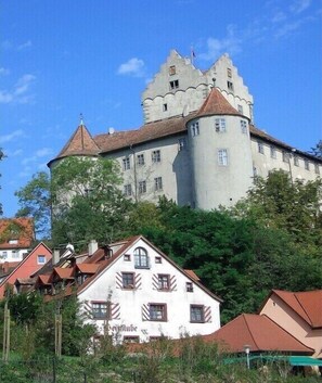 A castle-like building with multiple towers and a large central tower, surrounded by residential buildings. - in the Allgäu region, the Kleinert family (Argenbuehl-Eglofs)