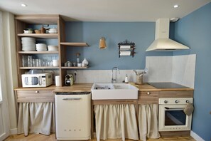 Eine kleine Küche mit Mikrowelle, Geschirrspüler, Spüle und Backofen.