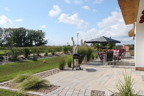 A patio with outdoor furniture, a grill, and a mailbox. - Holiday home in Mellnitz with swimming pool (Mellnitz)