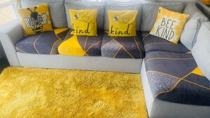 A sofa with geometric patterned cushions and a yellow throw rug. - Sunflower Lodge Luxury Pet Free Holiday Caravan (Filey)