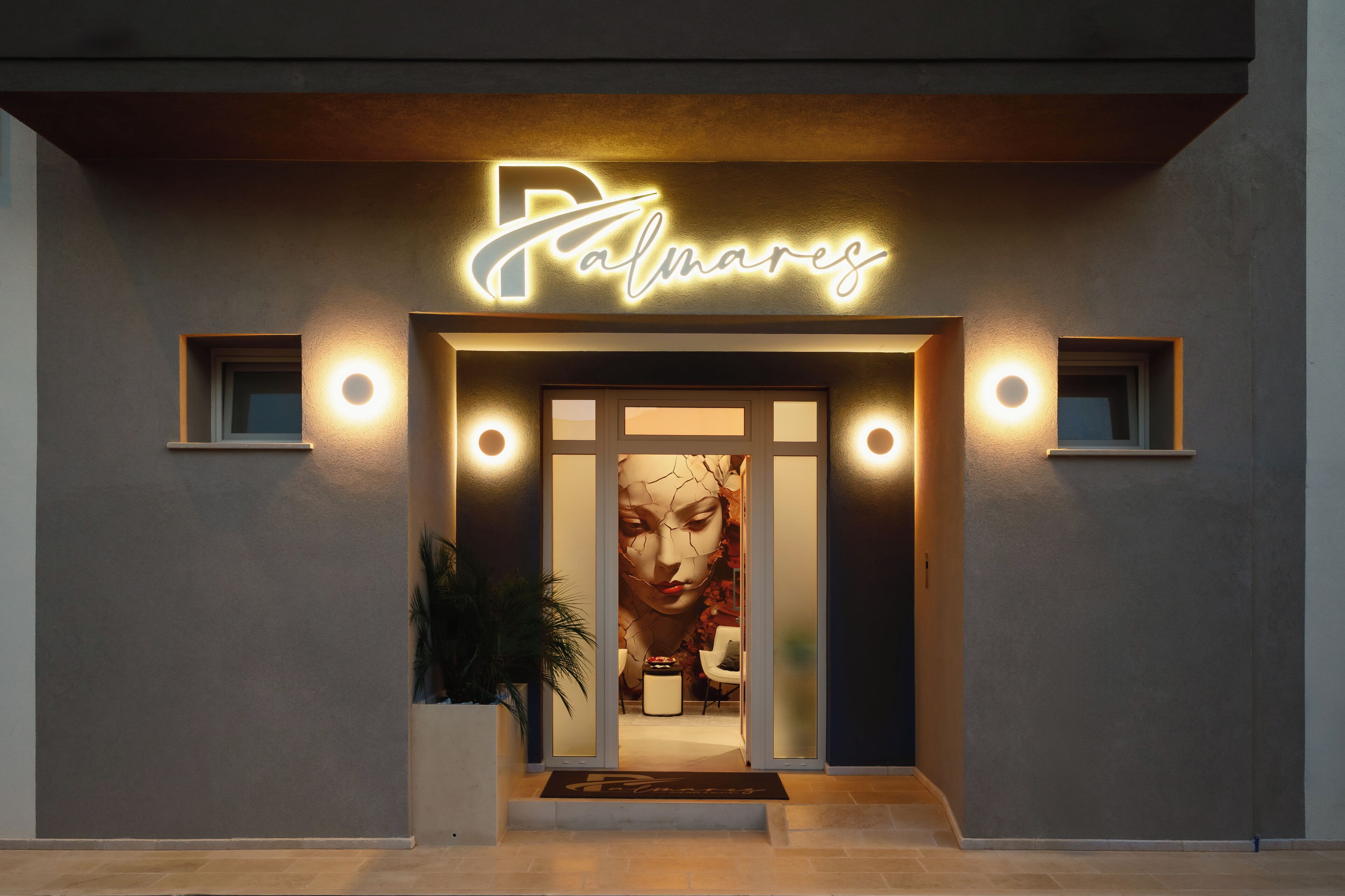 A building entrance with a sign reading 'Palmares.'