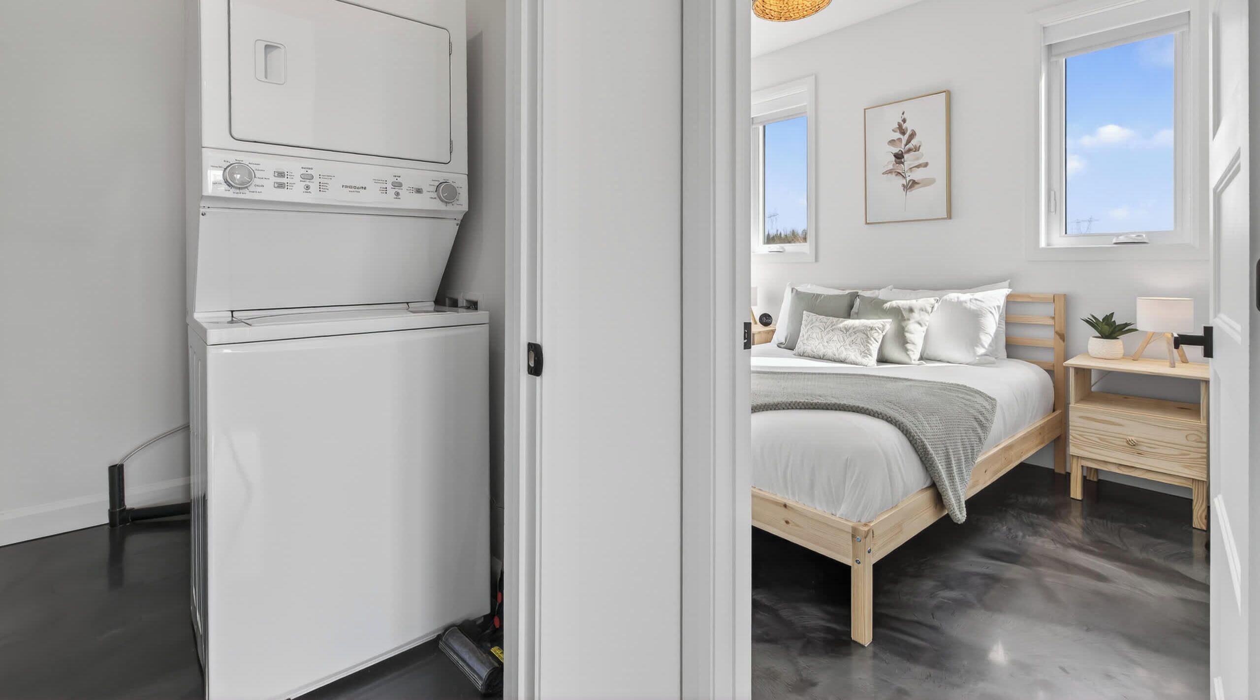 A bedroom with a bed, bedside table, and a window.