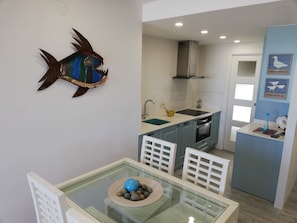 A modern kitchen with a sink, stove, and cabinets. - Deltamar 81, Solo Familias! (Playa Xeraco)
