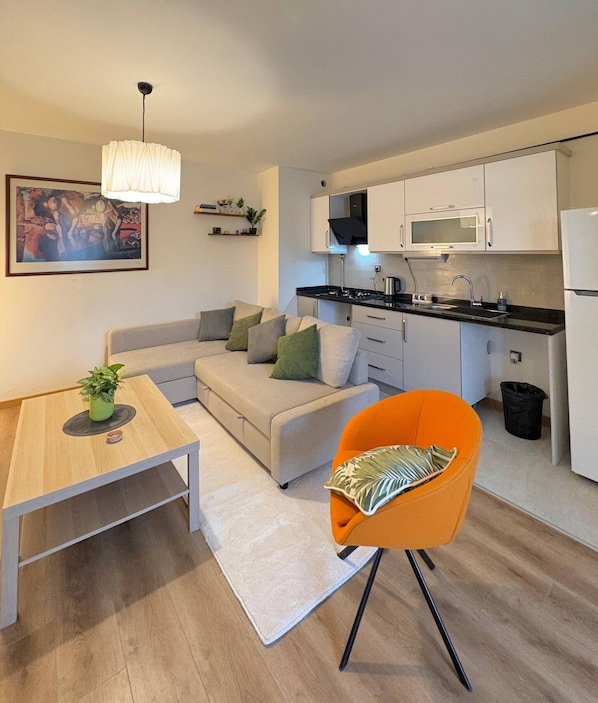 A modern kitchen with white cabinets, a black countertop, and a microwave. - 10 Mins to Takism - Central & New Modern Flat (Istanbul)