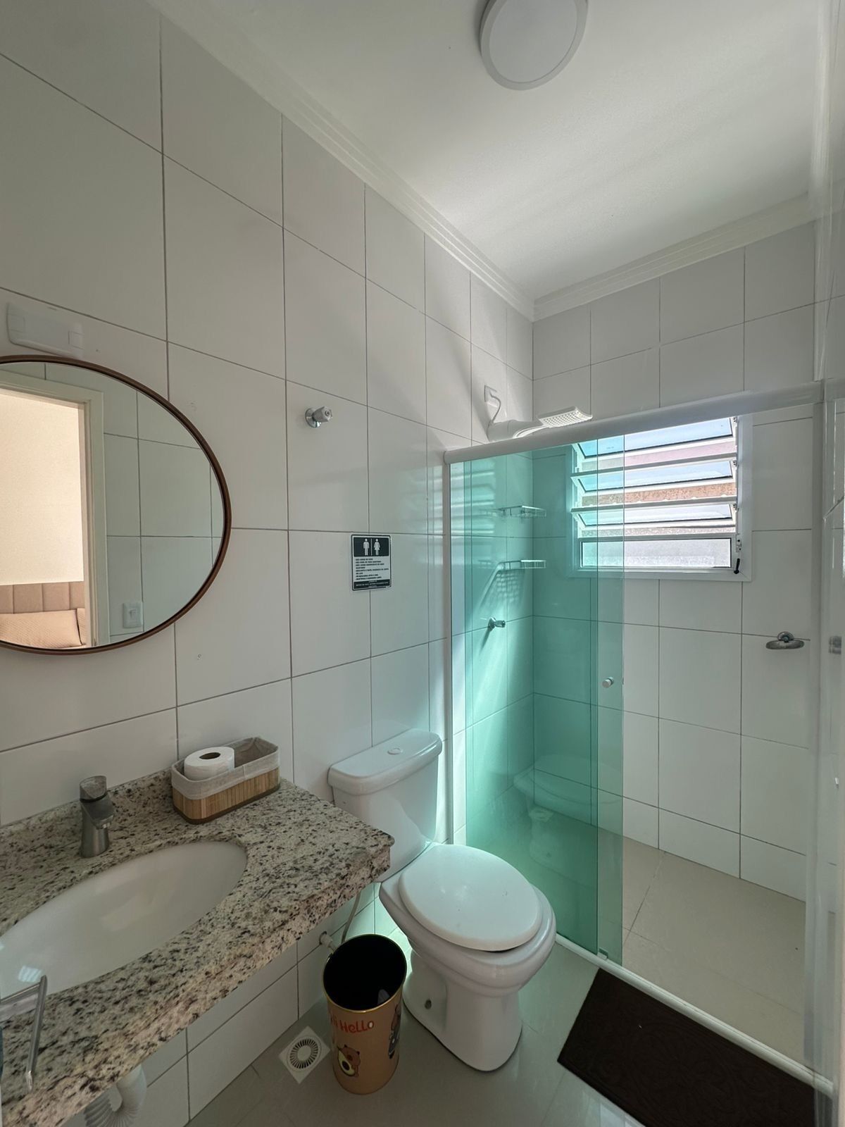 A bathroom with a toilet, sink, and shower.