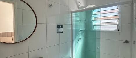 A bathroom with a toilet, sink, and shower.