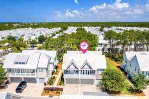 A residential area with multiple houses, a parking lot, and a clear view of the ocean. - 🦩Book Me Baby! Seaesta in Prominence🦩 (Inlet Beach)