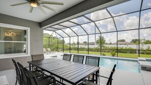 A covered patio with a pool, outdoor seating, and a view of the surrounding landscape. - Private Outdoor Oasis! Home 12 Mi to Flagler Beach (Palm Coast)