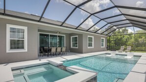 A covered swimming pool with lounge chairs and a ceiling fan. - Private Outdoor Oasis! Home 12 Mi to Flagler Beach (Palm Coast)