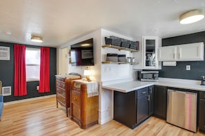 A compact kitchen with a microwave, dishwasher, and wooden cabinets. - Spokane Dual Suites! 3 Mi to Dtwn & Riverfront (Spokane)