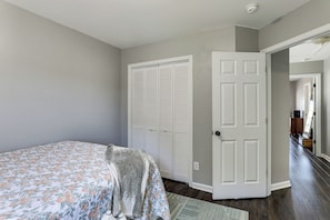 A bedroom with a bed, a closet, and a door leading to another room. - Community Pools + Dock: Moncks Corner Getaway (Moncks Corner)