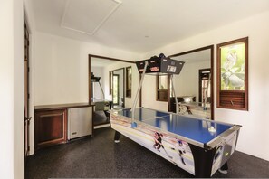 A room with a foosball table, a mirror, and a door leading to another room. - La Vida Dulce in Punta de Mita (Punta de Mita)