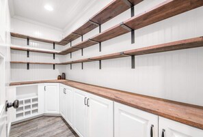 A kitchen with white cabinetry, wooden countertops, and exposed beams. - Smoky Pines Retreat, Sleeps 10, Hot Tub, Balcony (Sevierville)