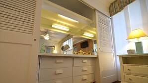 A room with a white dresser, a mirror, a lamp, and a ceiling fan. - Edgewater House - Ocean Front Units With Spectacular Views! (Rehoboth Beach)