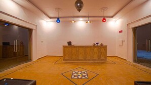 A reception area with a patterned counter, a geometric floor design, and pendant lighting. - Heritage resort  (Jaisalmer)